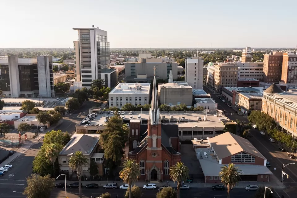 Aerial view of downtown Stockton, California with brick church in foreground.